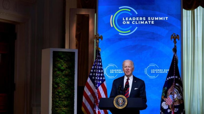 U.S. President Joe Biden at podium in front of blue screen