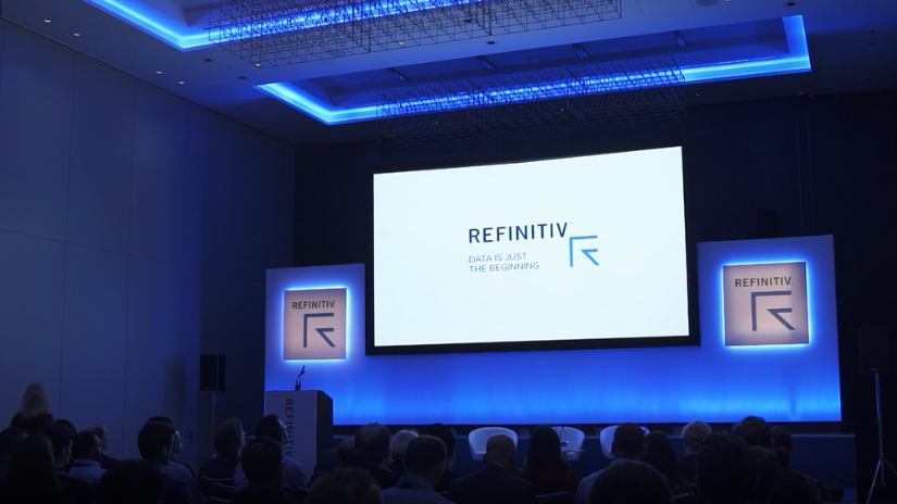 Giant screen featuring the Refinitiv logo at the Energy Interactive event
